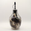 Ceramic oil bottle with swirling black, brown and cream glaze, unglazed base and metal pourer spout with black cap