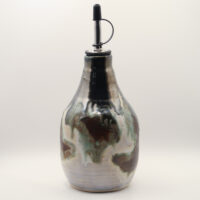 Ceramic oil bottle with metallic silver, black, green and reddish-brown drip glaze and a steel pour spout with black cap