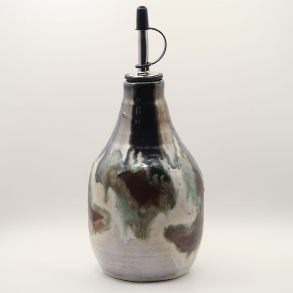 Ceramic oil bottle with metallic silver, black, green and reddish-brown drip glaze and a steel pour spout with black cap