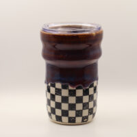 IMG_4212 Ceramic travel cup with clear plastic lid, glossy deep purple-brown glaze dripping over a black and white checkerboard base