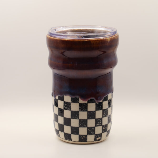 IMG_4212 Ceramic travel cup with clear plastic lid, glossy deep purple-brown glaze dripping over a black and white checkerboard base