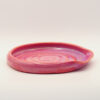 IMG_4226 Shallow ceramic spoon rest in pink and coral glaze with a spiral pattern inside and a notch in the rim for a handle