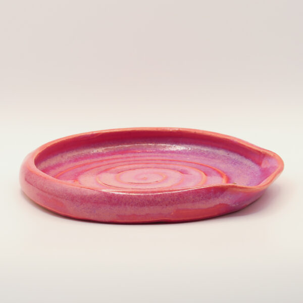 IMG_4226 Shallow ceramic spoon rest in pink and coral glaze with a spiral pattern inside and a notch in the rim for a handle