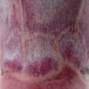 Close-up of a cup's glaze surface, mottled raspberry red, pink and lilac with speckled peach drips